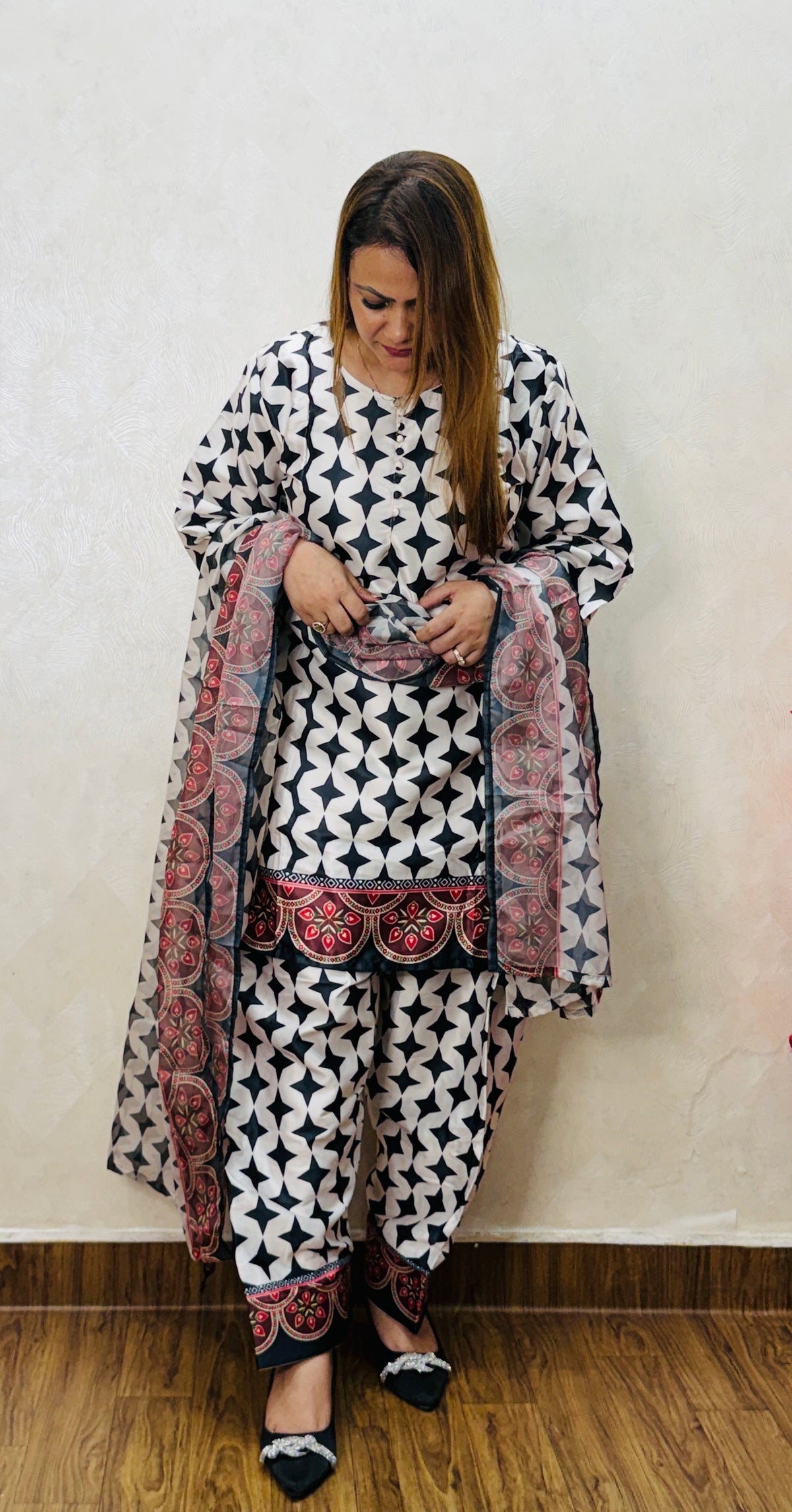 Close view of black and white geometric printed suit with red bordered dupatta detailing, SS-1008