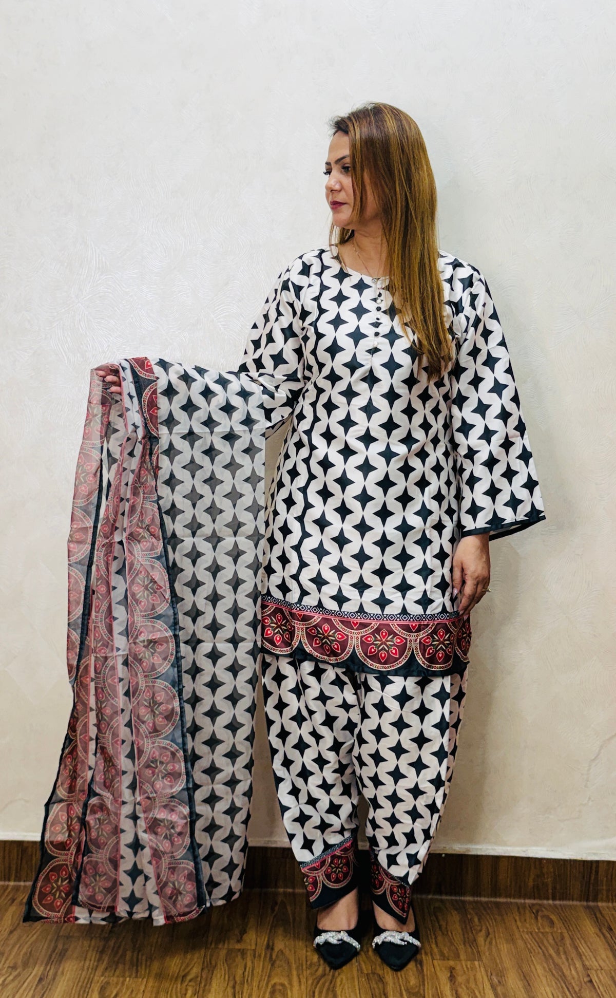 Black and white printed suit set with red bordered dupatta, holding drape – front view, SS-1008