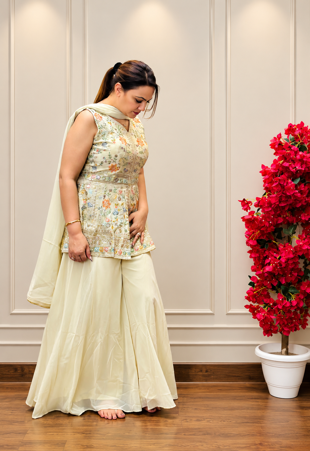 Side view of cream embroidered palazzo suit showing peplum top detailing and dupatta drape, SS-1013