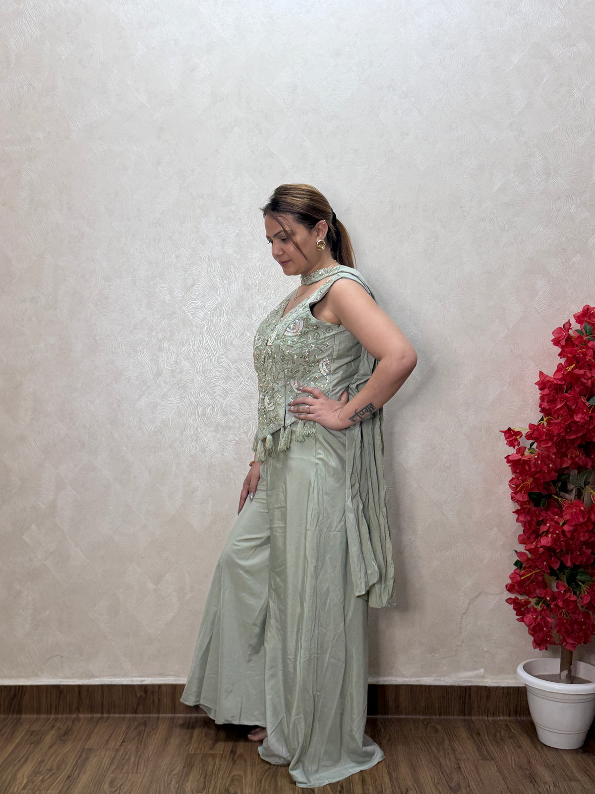 Side view of sage green indo-western dress showing embroidery detail and dupatta drape, SS-1011
